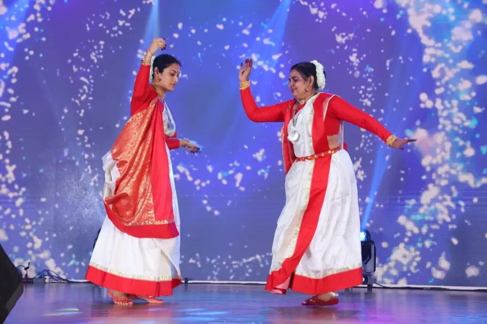 Sheela Ashok performing a classical dance duet under stage lights